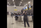 a woman standing in front of a counter with a few screens